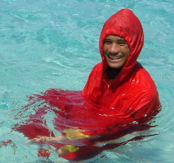 wet swimming poncho in the water